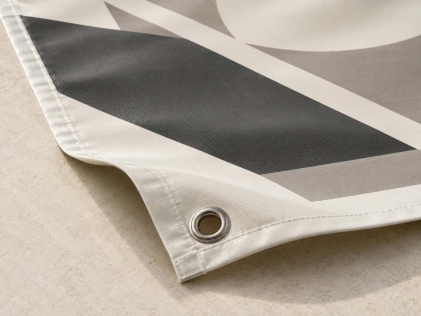 Corner of a printed vinyl banner with a steel grommet